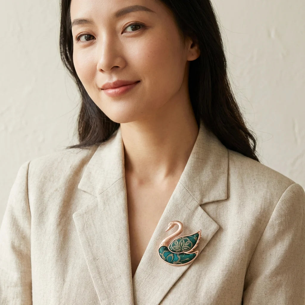 Emerald Green Shu Brocade Swan Brooch lifestyle worn on lapel — portrait styled