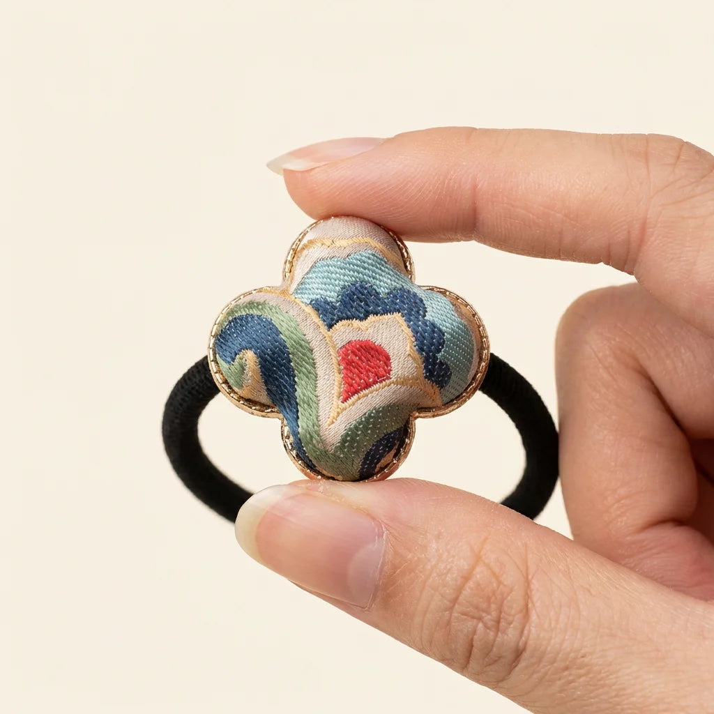 Clover Silk Brocade Hair Tie — Cloud Motif held in fingertips SIZE scale reference