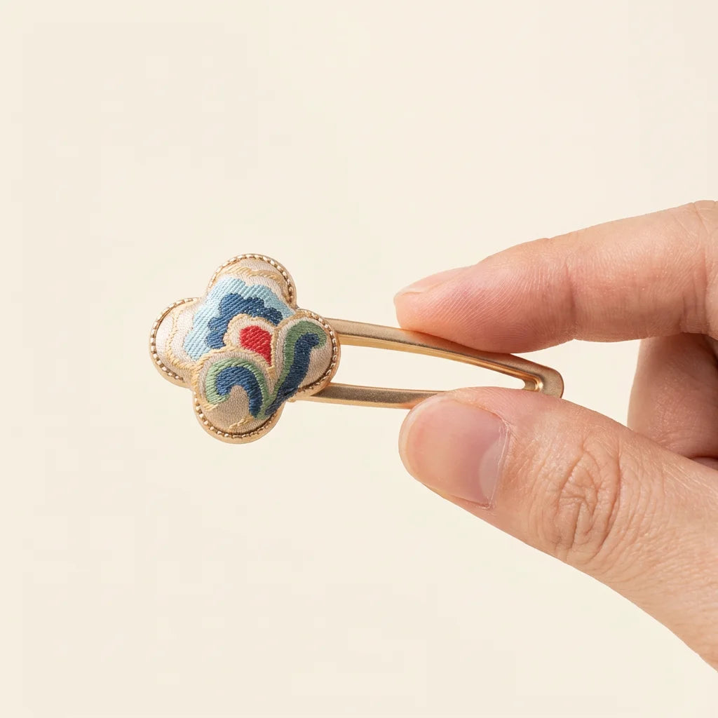 Clover Silk Brocade Snap Hair Clip — Cloud Motif held in fingertips SIZE scale reference