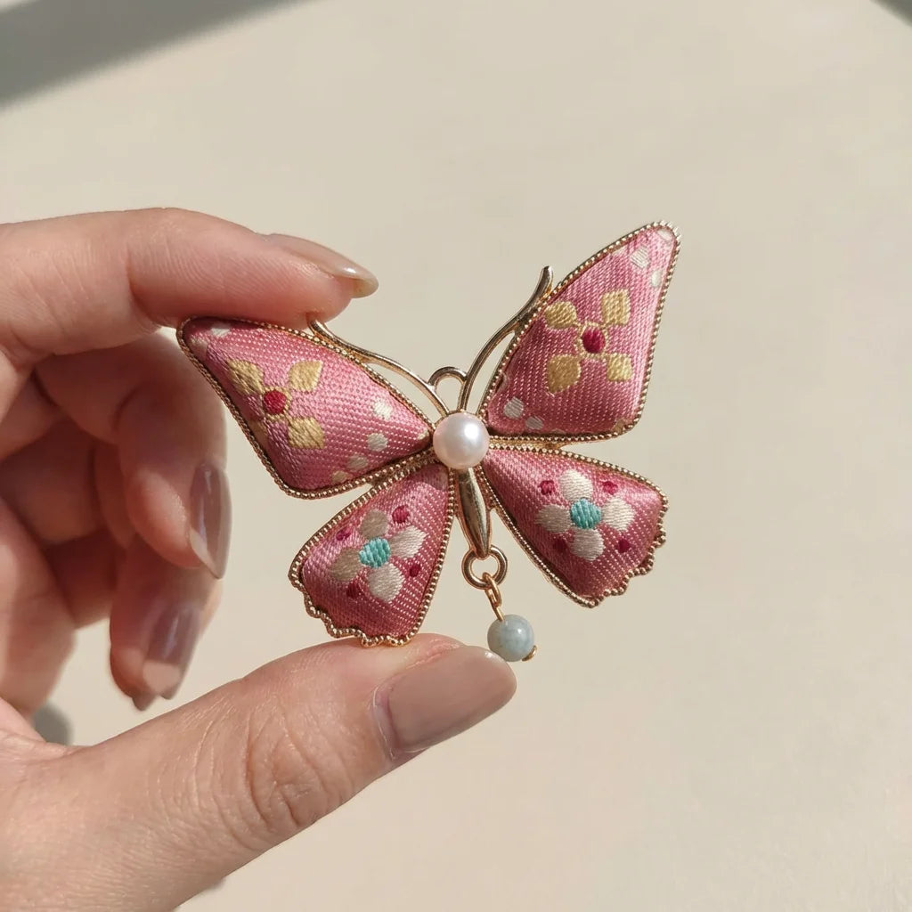 Pink Butterfly Shu Brocade Silk Brooch — held in hand SIZE scale reference