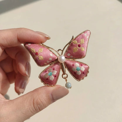 Pink Butterfly Shu Brocade Silk Brooch — held in hand SIZE scale reference