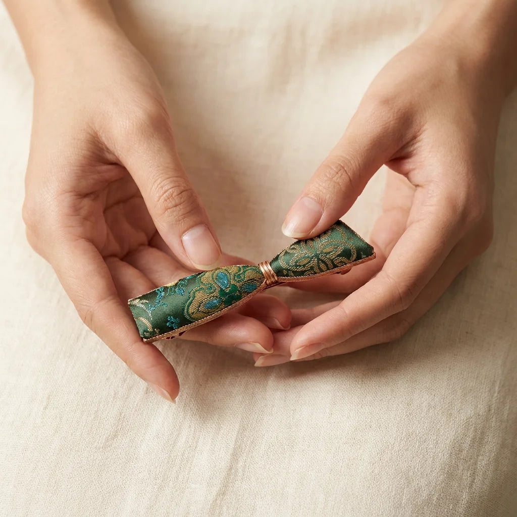 Emerald Green Shu Brocade Bow Hair Clip size reference — held in hand scale