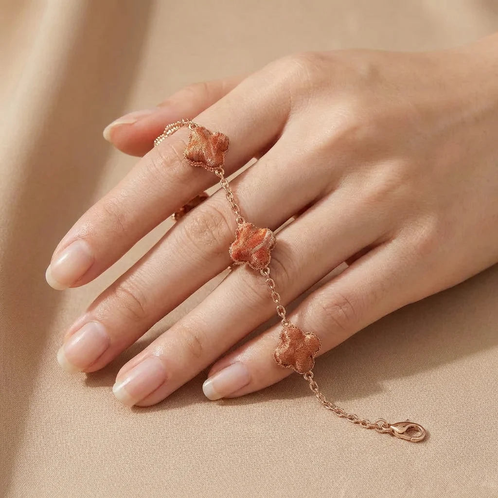 Clover Silk Brocade Chain Bracelet — Terracotta held in fingertips SIZE scale reference