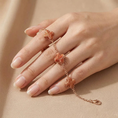 Clover Silk Brocade Chain Bracelet — Terracotta held in fingertips SIZE scale reference