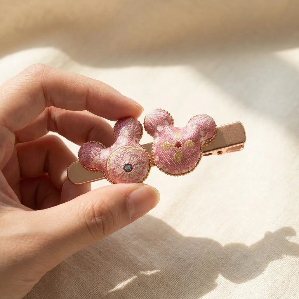 Pink Blossom Mickey Silk Hair Clip — lifestyle scene hanging from bag