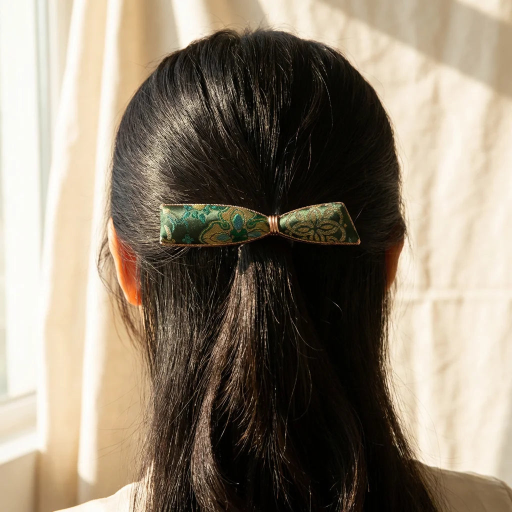 Emerald Green Shu Brocade Bow Hair Clip worn in hair — lifestyle scene portrait